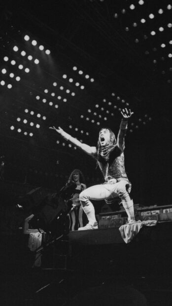 A lead singer from Iron Maiden band passionately performs on stage during a concert, HD Phone Wallpaper