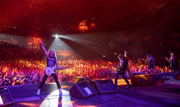 The Iron Maiden band plays music in front of a large cheering crowd, HD Desktop Wallpaper