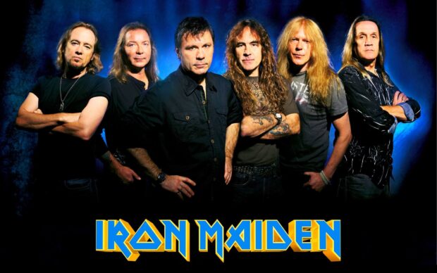 The Iron Maiden band members are standing with folded arms under blue lighting, HD Desktop Wallpaper