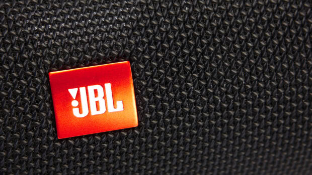 The JBL logo is displayed on a red square against a black woven fabric background, HD Desktop Wallpaper