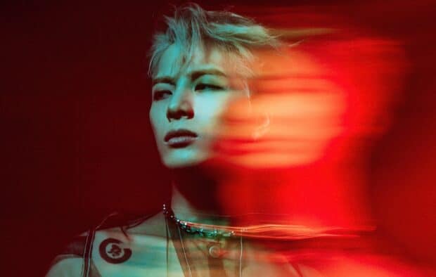 An artistic portrait of Jackson Wang with motion blur and vibrant red lighting, HD Desktop Wallpaper