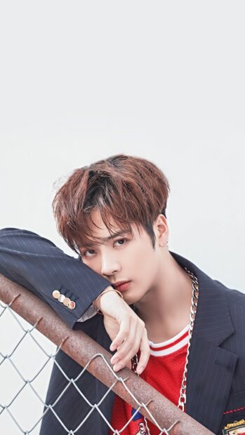 Jackson Wang wallpapers showing a thoughtful expression near a metal fence, HD Phone Wallpaper