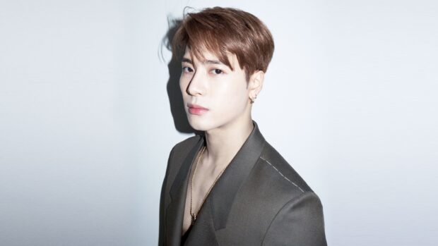 Jackson Wang in a stylish suit looking confidently at the camera, 2K Desktop Wallpaper