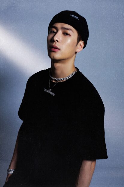 A close up of Jackson Wang wearing a black beanie and necklace against a gray background, HD Phone Wallpaper