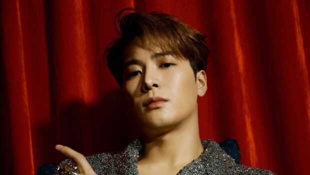 A close up of Jackson Wang with a red curtain background and shiny outfit, HD Desktop Wallpaper