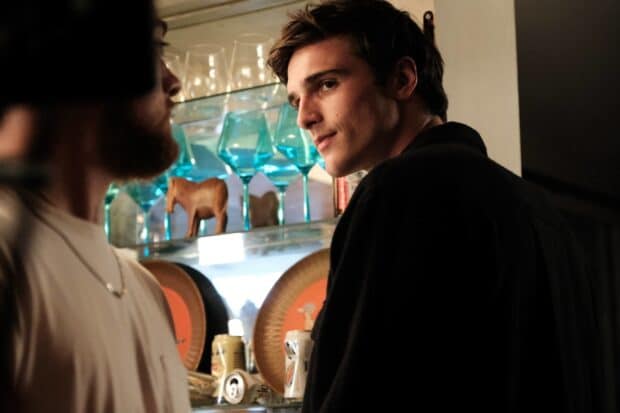 Jacob Elordi wallpapers shows a young man looking thoughtfully at someone in a dimly lit setting, HD Desktop Wallpaper