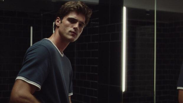 Jacob Elordi looks thoughtful in a dimly lit room with black tiled walls, HD Desktop Wallpaper
