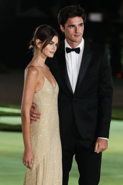 Jacob Elordi is standing beside a woman in a sparkling dress at an evening event, HD Mobile Wallpaper