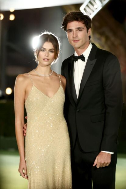 Jacob Elordi stands beside a woman in a glamorous dress at a formal event, HD Mobile Wallpaper