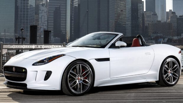 A white Jaguar F Type convertible parked on a wooden dock with city buildings in the background, HD Desktop Wallpaper