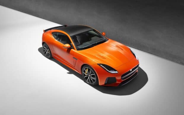 A bright orange Jaguar F Type is parked on a gray and white surface, 2K Desktop Wallpaper