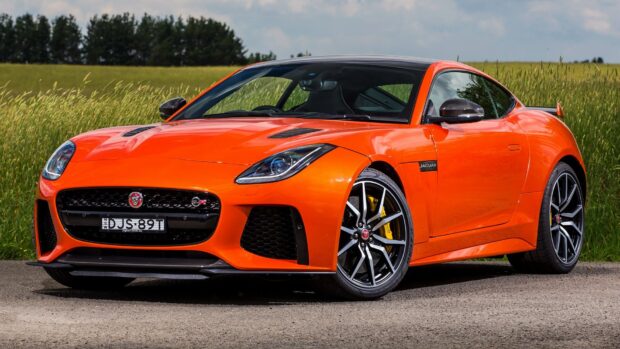 A vibrant orange Jaguar F Type sports car parked outdoors by the grass field, HD Desktop Wallpaper