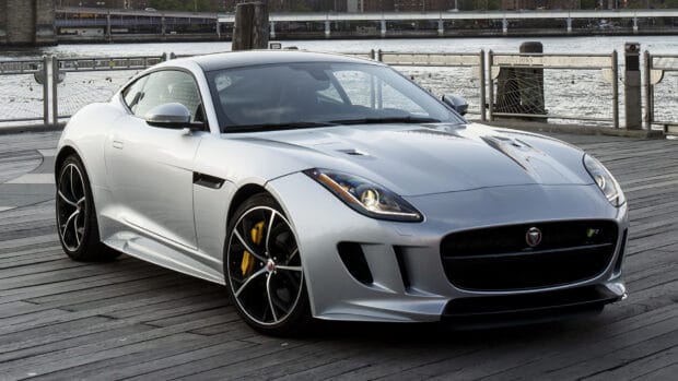 A silver Jaguar F Type is parked near the waterfront with detailed rims and headlights, HD Desktop Wallpaper