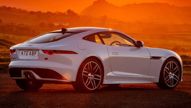 A white Jaguar F Type car is parked on a road with an orange sunset background, HD Desktop Wallpaper