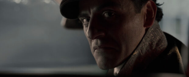 Jake Lockley is shown with intense expression in dim light, 2K Desktop Wallpaper