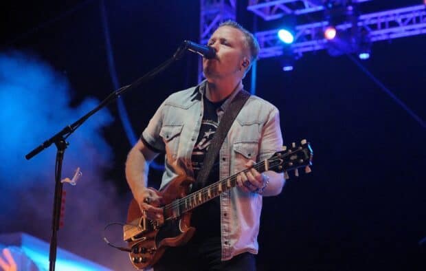 Jason Isbell is playing guitar and singing during a concert, HD Desktop Wallpaper