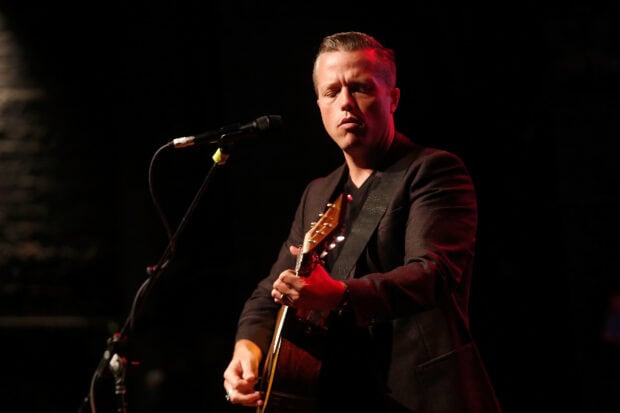 Jason Isbell is performing on stage playing guitar during a live concert, HD Desktop Wallpaper