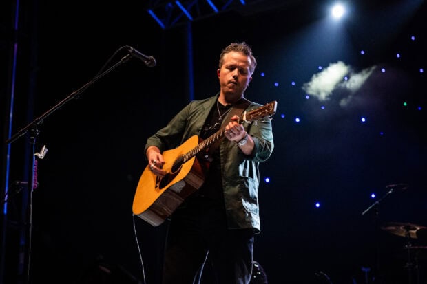 Jason Isbell performing live music with his guitar under blue stage lights, HD Desktop Wallpaper