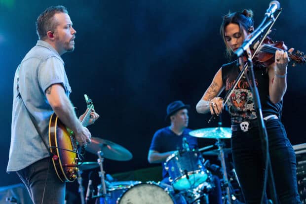 Jason Isbell performing on stage with band members in a concert setting, HD Desktop Wallpaper