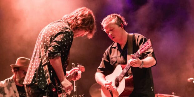 Jason Isbell playing guitar on stage during a concert performance, HD Desktop Wallpaper