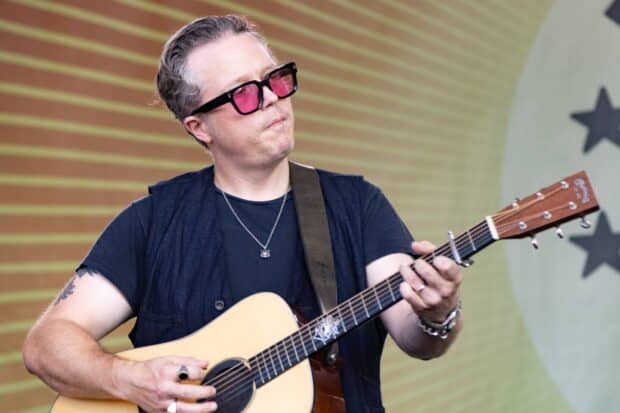Jason Isbell is performing on stage with a guitar and wearing pink sunglasses, HD Desktop Wallpaper