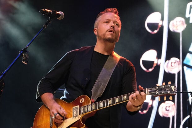 Jason Isbell plays a guitar during a live concert performance, HD Desktop Wallpaper