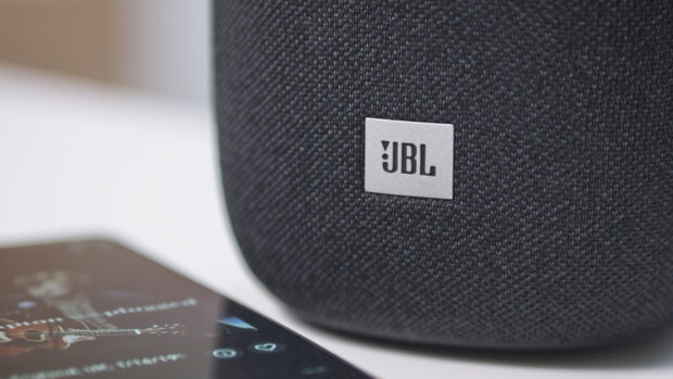A close up view of a JBL speaker and a smartphone showing music controls, HD Desktop Wallpaper