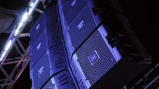 The Jbl stack is illuminated in blue lights at a concert stage, HD Desktop Wallpaper