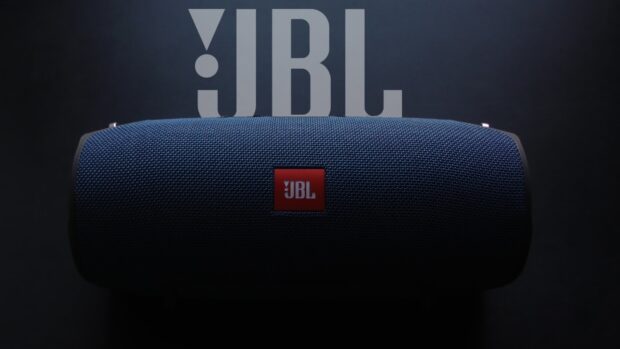 A blue JBL speaker is displayed with the brand logo visible against a dark background, HD Desktop Wallpaper