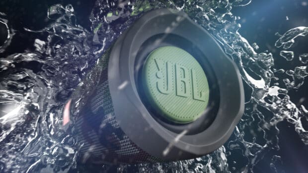 A JBL speaker is surrounded by dynamic water splashes in motion, HD Desktop Wallpaper