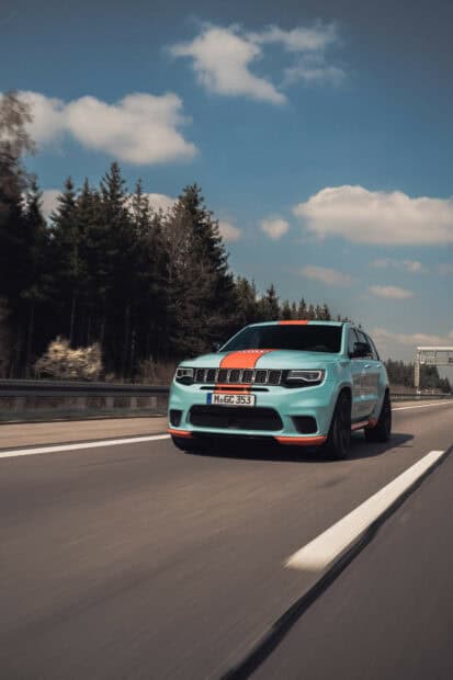 A Jeep Grand Cherokee is driving on a clear highway with trees and clouds in the background, HD Mobile Wallpaper