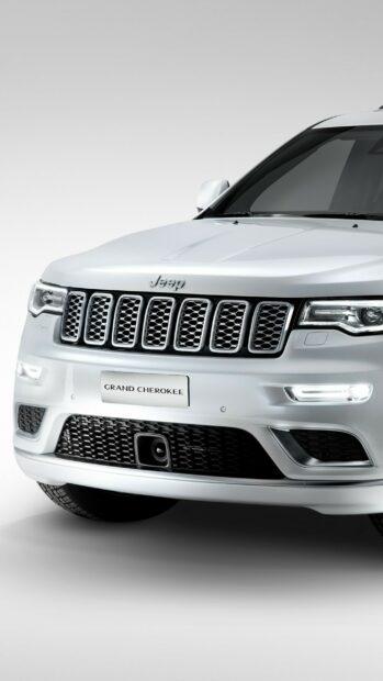 A white Jeep Grand Cherokee front grille and headlights are shown in this image, 2K Phone Wallpaper