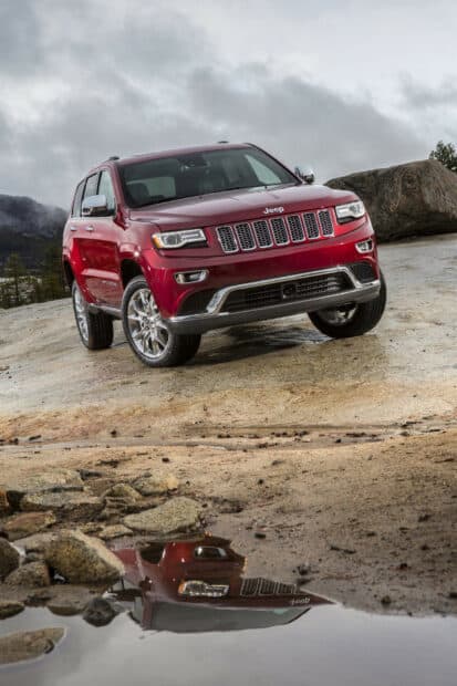 A red Jeep Grand Cherokee is parked on rocky terrain with mountains in the background, HD Mobile Wallpaper