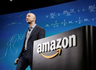 Jeff Bezos is delivering a speech with mathematical formulas displayed in the background related to Amazon, HD Desktop Wallpaper