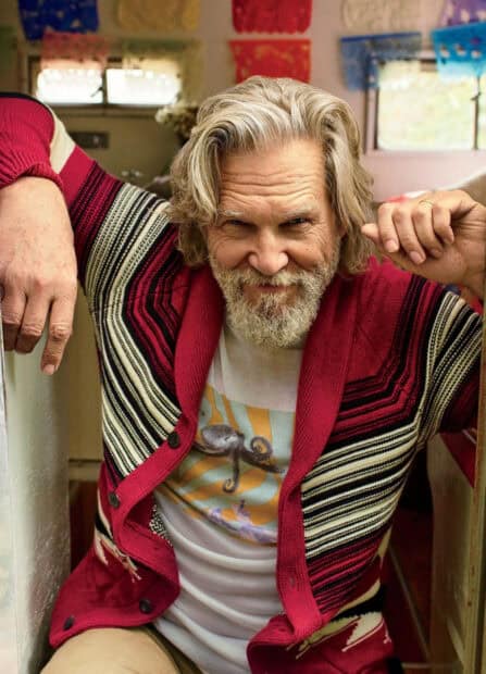 Jeffrey Bridges sits confidently wearing a red and striped cardigan with a playful expression, HD Mobile Wallpaper