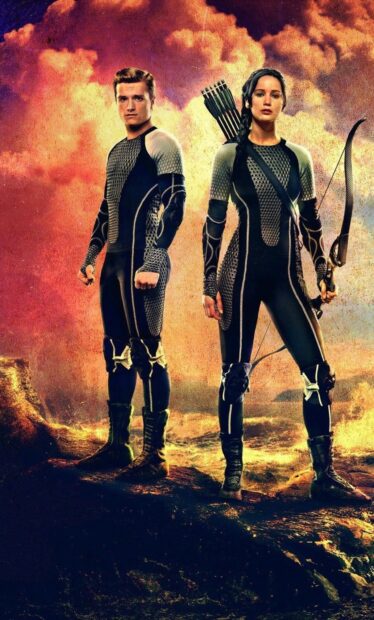 Jennifer Lawrence and Josh Hutcherson stand ready in futuristic outfits from The Hunger Games, HD Phone Wallpaper