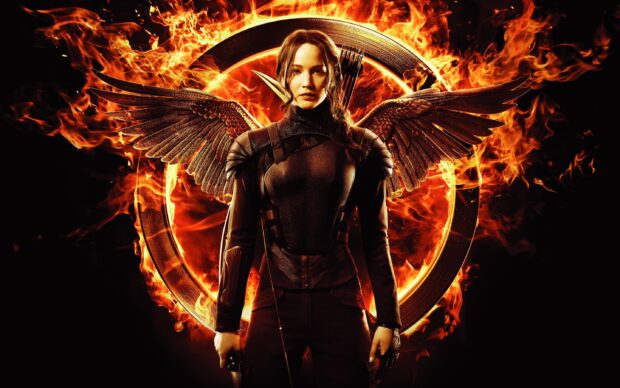 Jennifer Lawrence as Katniss Everdeen standing with flaming mockingjay wings and bow, 2K Desktop Wallpaper