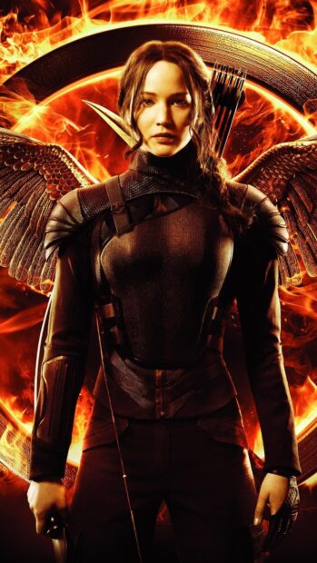 Jennifer Lawrence stands ready with bow and arrow against a fiery background from The Hunger Games, 4K Mobile Wallpaper