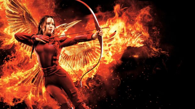 Jennifer Lawrence aims her bow with fiery wings in the background, 4K Desktop Wallpaper