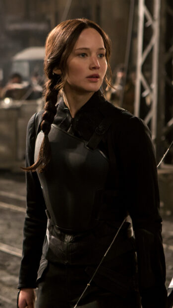 Jennifer Lawrence is dressed in battle armor in a dark setting from The Hunger Games, HD Phone Wallpaper