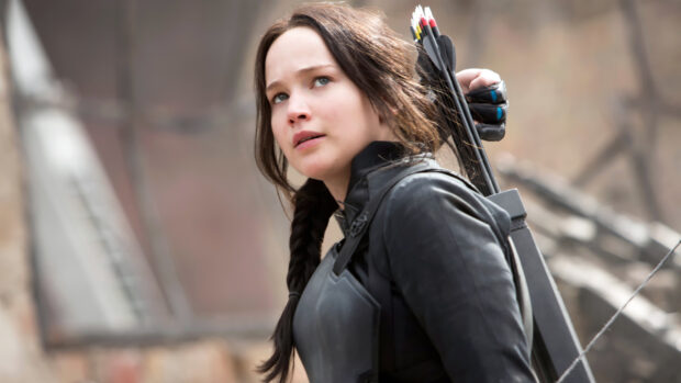 Jennifer Lawrence is seen focused and ready with her bow in The Hunger Games, 4K Desktop Wallpaper