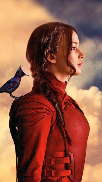 Jennifer Lawrence from The Hunger Games stands with a bird on her shoulder wearing a red suit, HD Phone Wallpaper