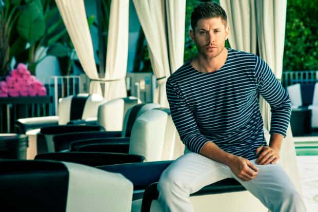 Jensen Ackles is sitting on a chair wearing a striped shirt in an outdoor lounge area, HD Desktop Wallpaper