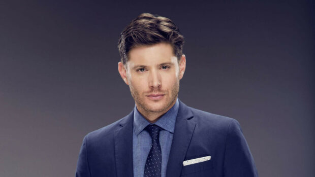 Jensen Ackles stands confidently in a blue suit and tie with a serious expression, HD Desktop Wallpaper