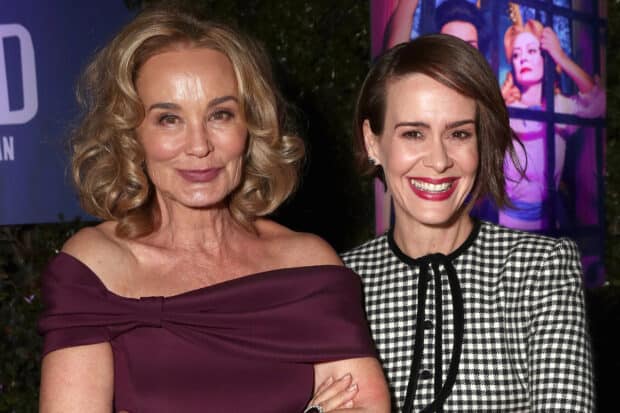 Jessica Lange and Sarah Paulson smiling at an event with vibrant background posters, HD Desktop Wallpaper