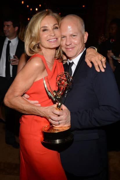 Jessica Lange holding an Emmy award while smiling with a man in a formal event, 2K Portrait Wallpaper