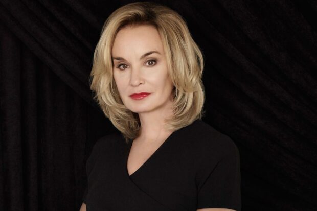 Jessica Lange with blonde hair wearing a black dress in front of a dark background, HD Desktop Wallpaper