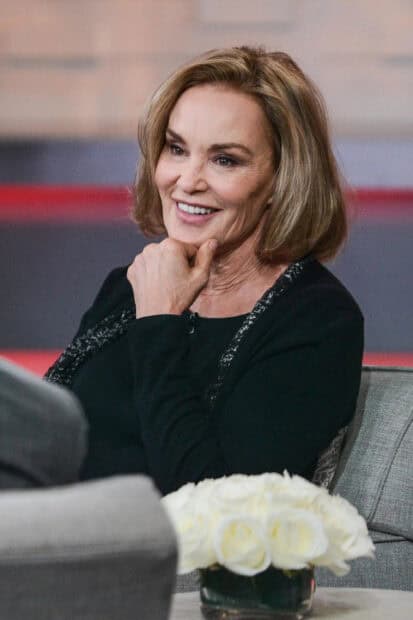 Jessica Lange smiles warmly while sitting on a couch during an interview, 2K Portrait Mobile Wallpaper