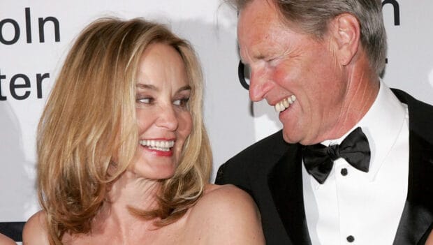 Jessica Lange smiles warmly with a man dressed in a tuxedo at an event, HD Desktop Wallpaper