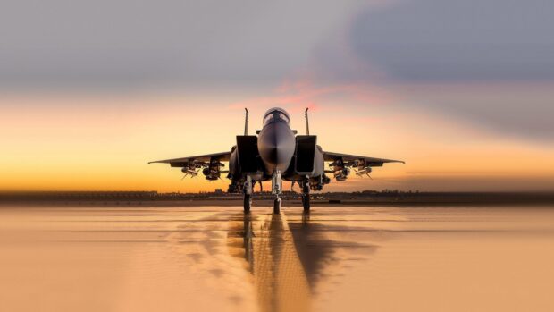 A jet fighter stands ready on a wet runway with a sunset sky in the background, HD Desktop Wallpaper